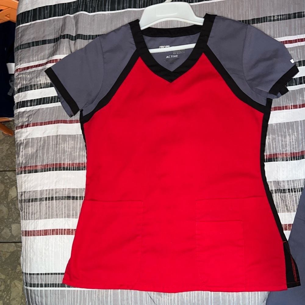 Beautiful shirt it is true red except on the photos. It looks orange